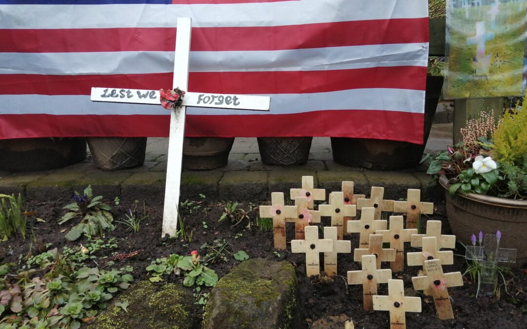 Image of memorial with cross and USA flag