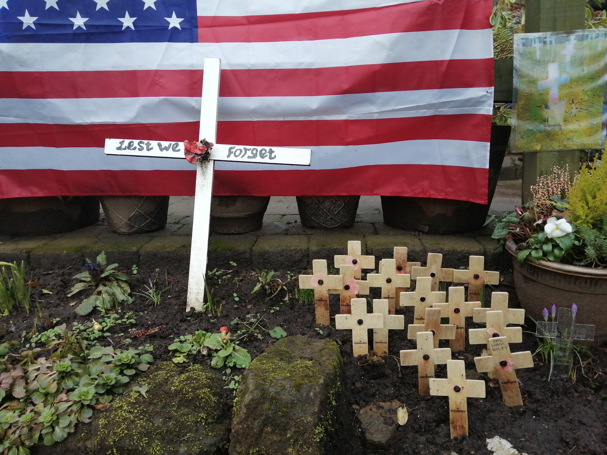 Image of memorial with cross and USA flag