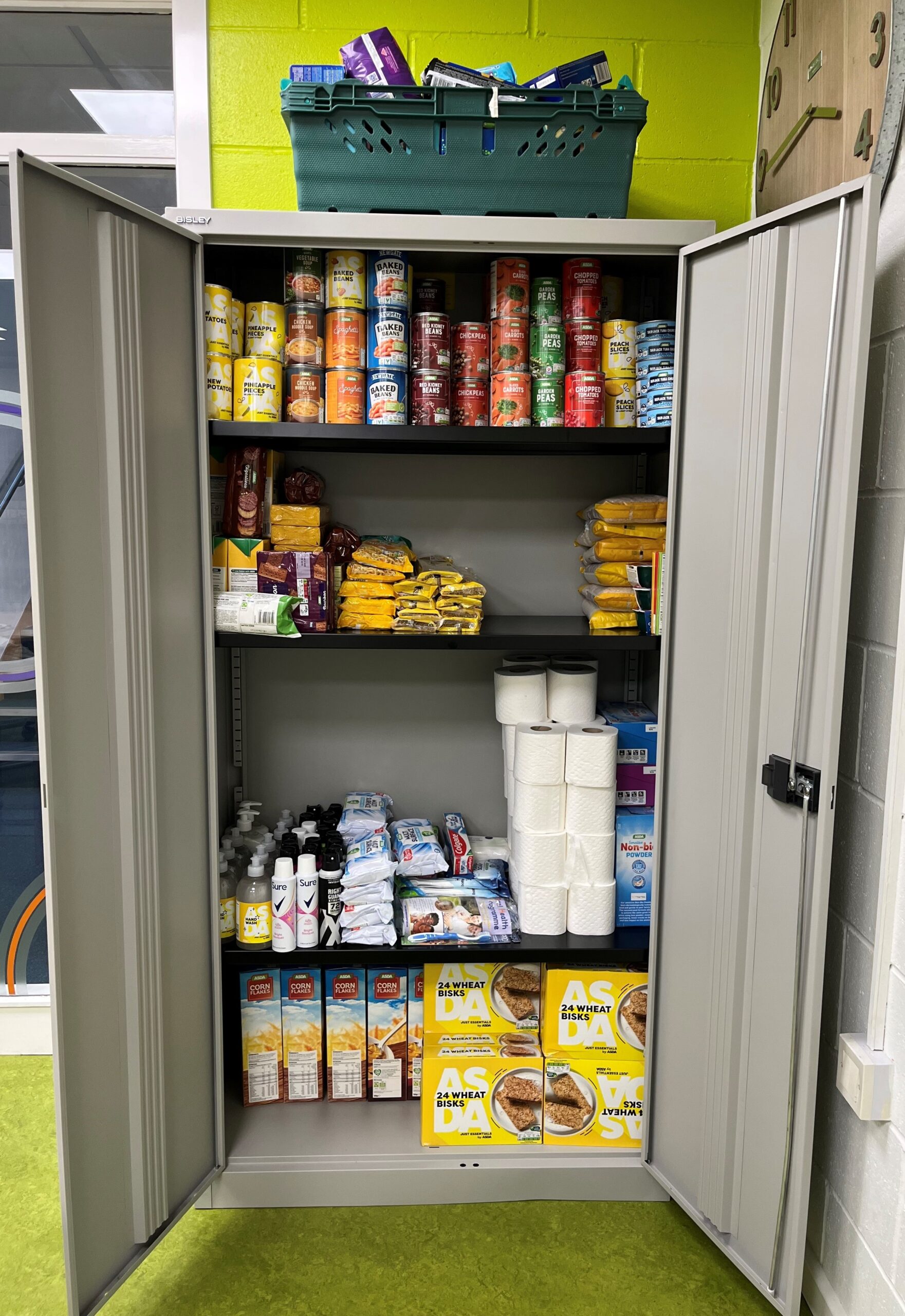 a cupboard containing tinned food and toiletries