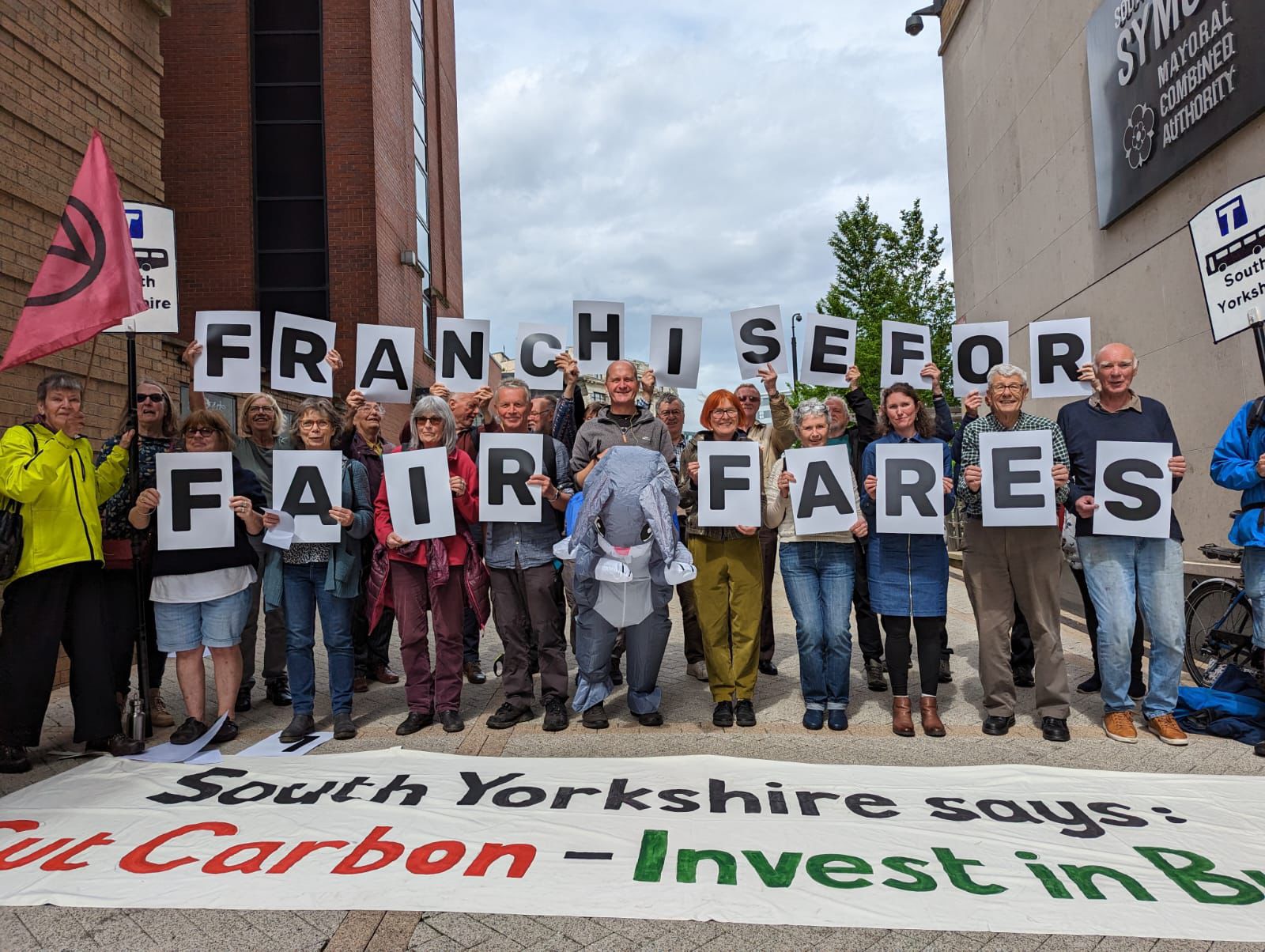 Better Buses South Yorkshire protesting, holding signs that spell out 'Franchise for Fair Fares'.