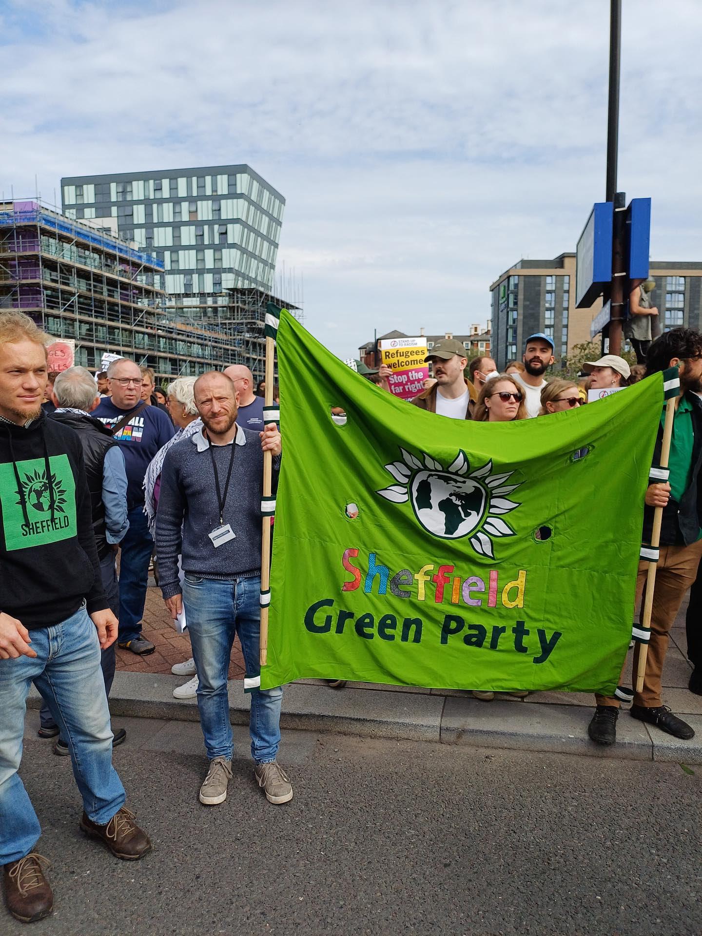 Green Party members hold Green Party banner