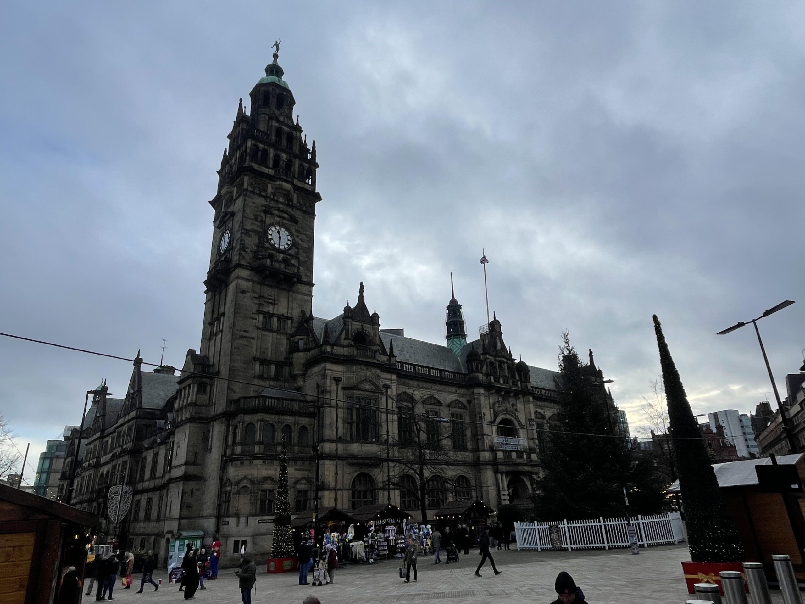 Sheffield Town Hall with Christmas market stalls in view.