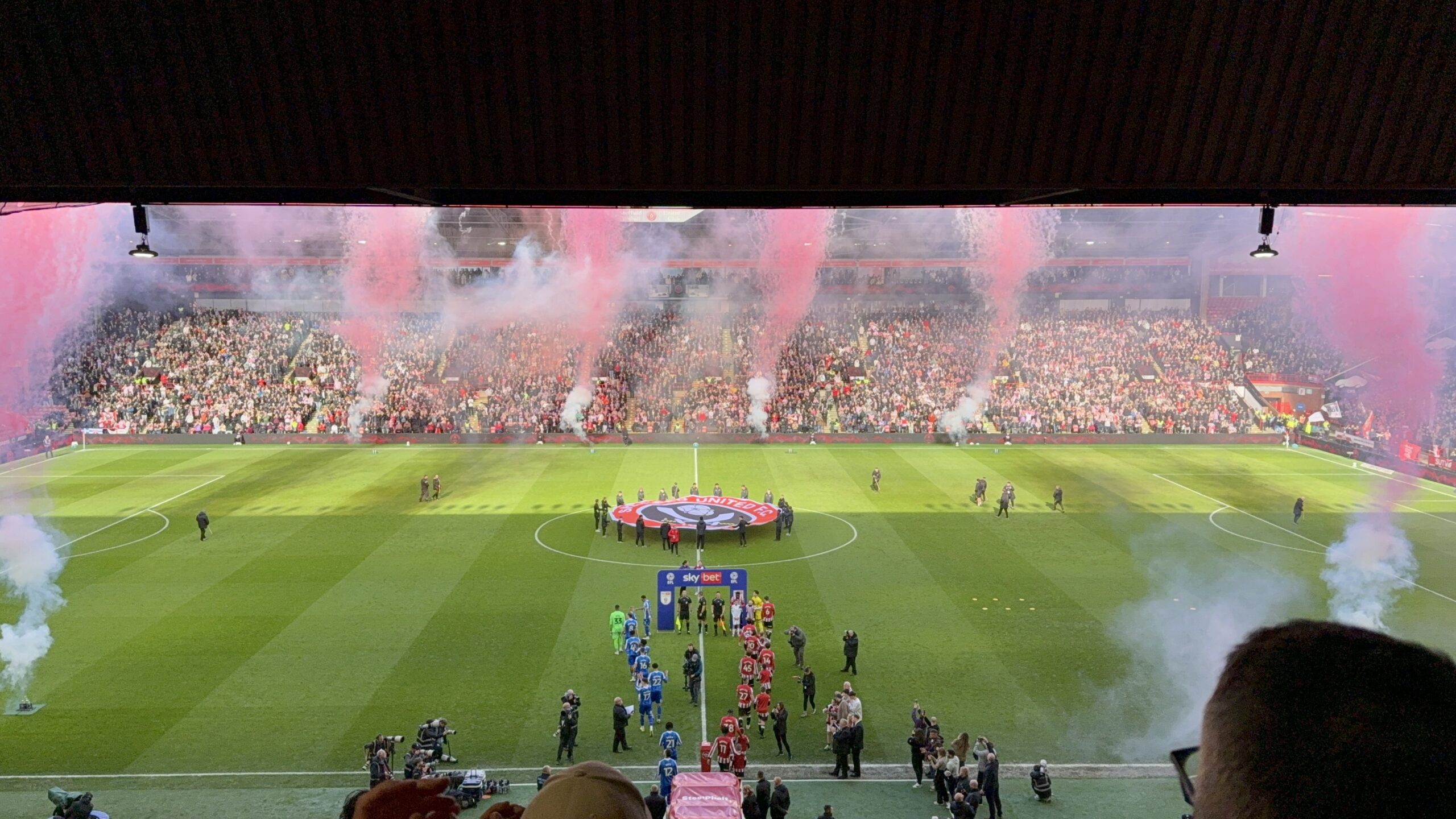 The two teams walk out surrounded by red fire works for the Steel-City derby